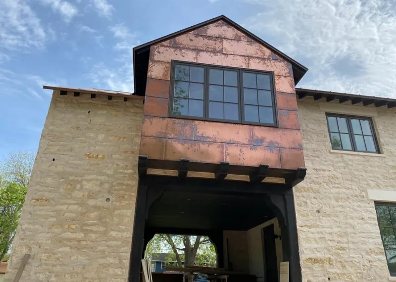 Copper metal panel facade on a stone building for Metal Roof Coating in Eagle Mountain